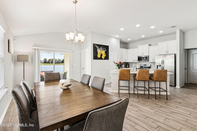 dining area with visible vents, an inviting chandelier, light wood-style flooring, recessed lighting, and vaulted ceiling