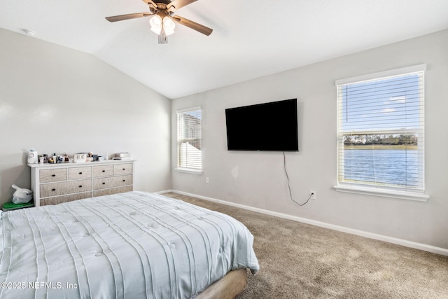 bedroom with vaulted ceiling, carpet flooring, baseboards, and ceiling fan