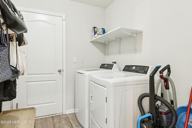 laundry area with laundry area, wood tiled floor, and washer and clothes dryer