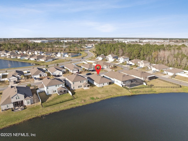 drone / aerial view with a residential view and a water view