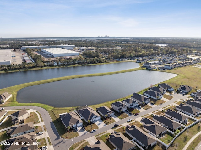 birds eye view of property with a residential view and a water view