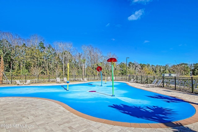 view of pool featuring fence