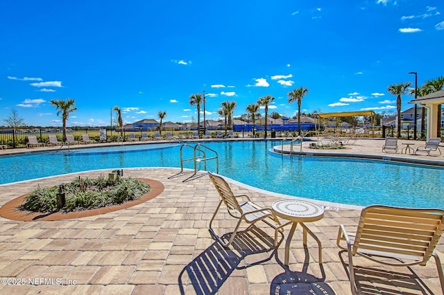 pool featuring a patio area and fence