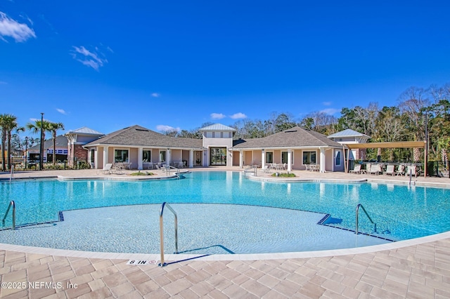 pool with a patio and fence