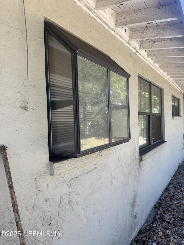 exterior details featuring stucco siding