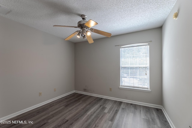 empty room featuring baseboards, a textured ceiling, wood finished floors, and a ceiling fan