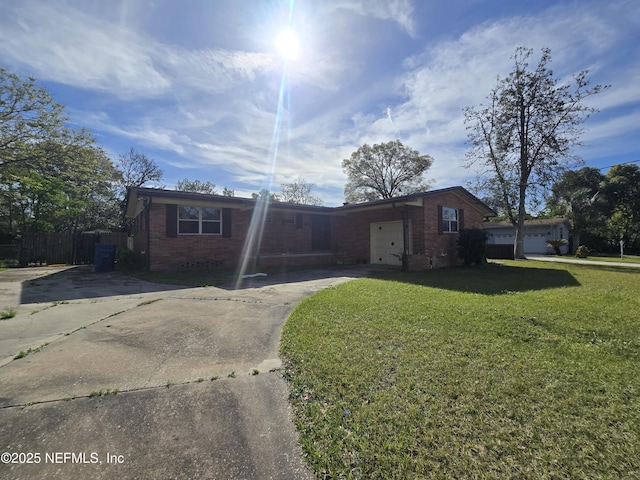 single story home featuring a front lawn, a garage, brick siding, and driveway