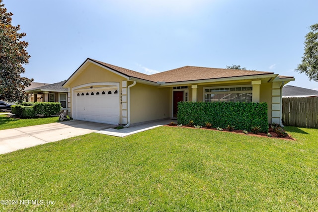 single story home with stucco siding, an attached garage, a front lawn, and fence