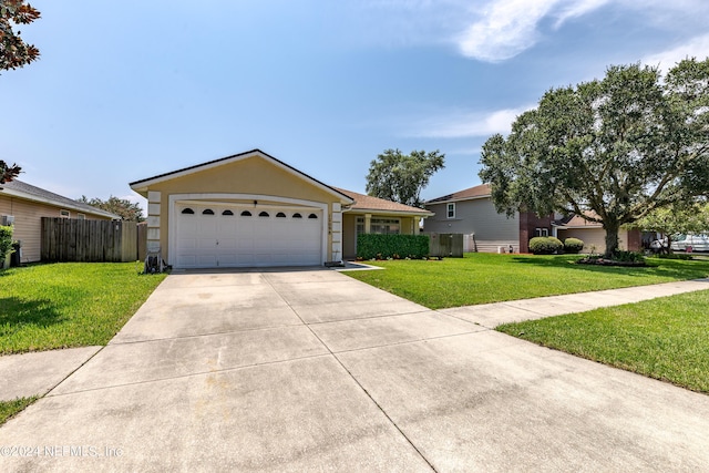 ranch-style house featuring a front yard, fence, a garage, and driveway