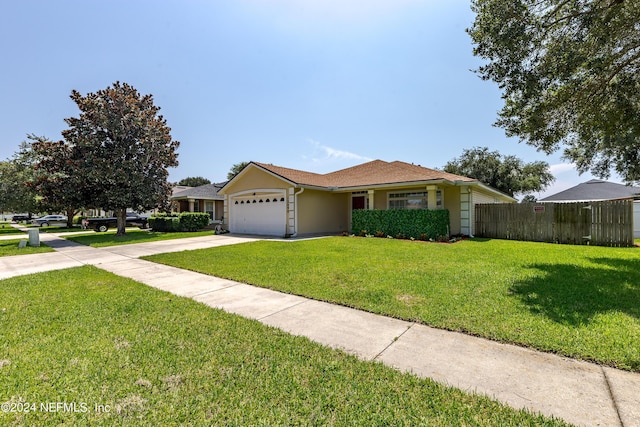 single story home featuring fence, concrete driveway, a front yard, stucco siding, and a garage