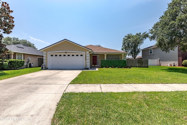 ranch-style house with an attached garage, concrete driveway, a front lawn, and fence