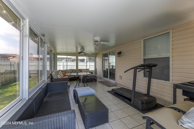 sunroom / solarium featuring a ceiling fan