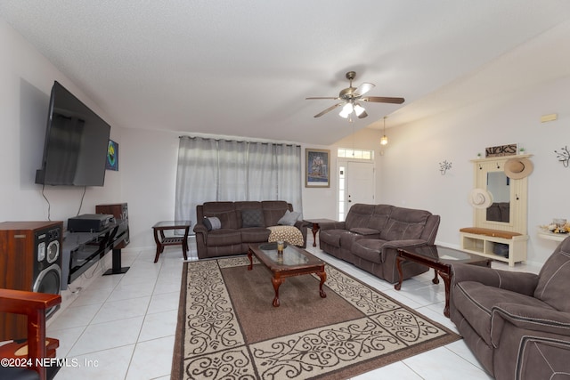 living area featuring light tile patterned floors, a ceiling fan, and vaulted ceiling