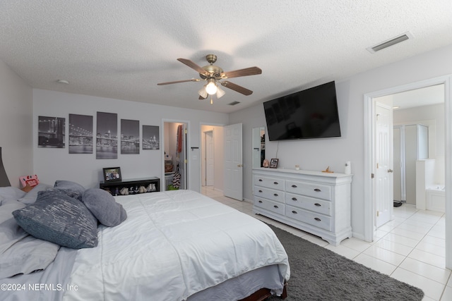 bedroom with ceiling fan, visible vents, a textured ceiling, and light tile patterned flooring