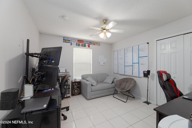 office area with light tile patterned flooring, a textured ceiling, and a ceiling fan