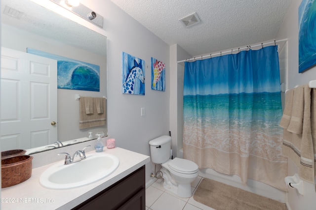 full bath with vanity, visible vents, tile patterned flooring, a textured ceiling, and toilet