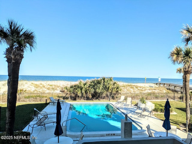 view of pool featuring a patio area, a fenced in pool, a water view, and fence