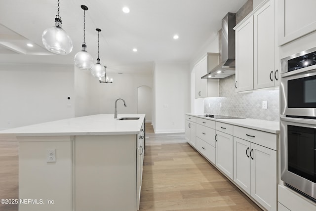 1646 County Road 315b, Green Cove Springs, FL 32043 - kitchen featuring black electric stovetop, double oven, a sink, wall chimney range hood, and a kitchen island with sink