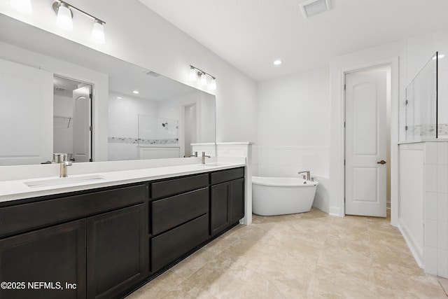 1646 County Road 315b, Green Cove Springs, FL 32043 - bathroom with a tile shower, a sink, visible vents, a freestanding bath, and double vanity
