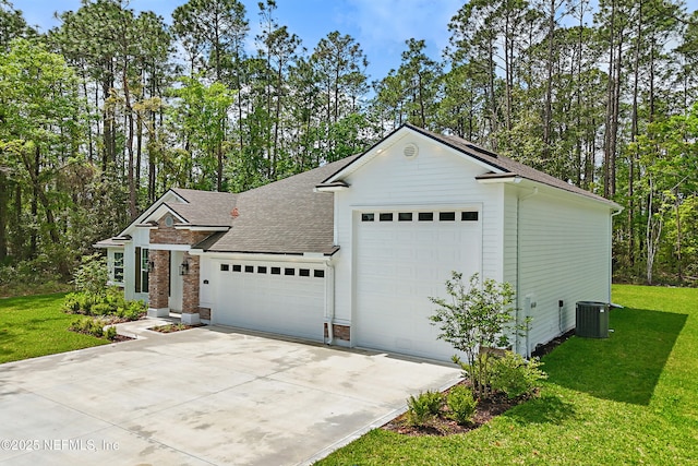 1646 County Road 315b, Green Cove Springs, FL 32043 - view of front of home with a garage, central AC, concrete driveway, a front lawn, and a shingled roof