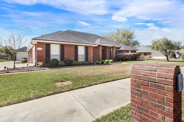 ranch-style house featuring driveway, brick siding, a front lawn, and a shingled roof