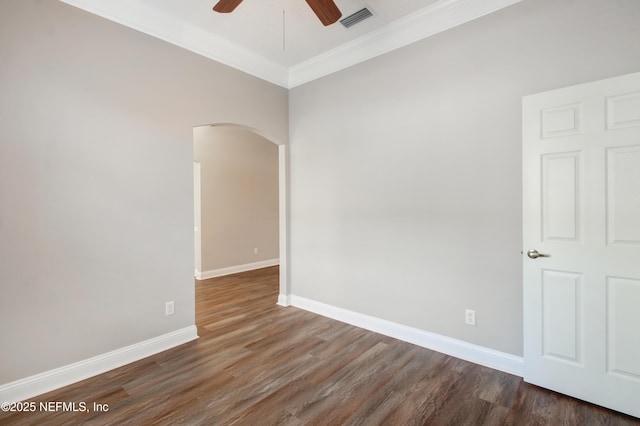 unfurnished room with visible vents, ornamental molding, wood finished floors, arched walkways, and a ceiling fan