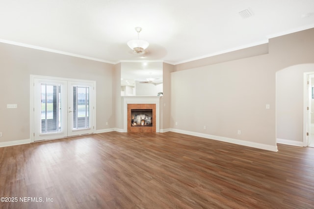 unfurnished living room with baseboards, wood finished floors, a ceiling fan, and crown molding