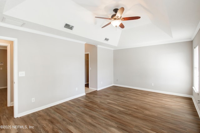 unfurnished room featuring visible vents, wood finished floors, a ceiling fan, and ornamental molding