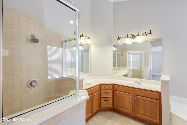 full bathroom with tile patterned flooring, a stall shower, double vanity, and a sink