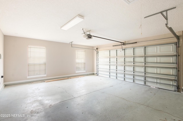 garage featuring baseboards and a garage door opener