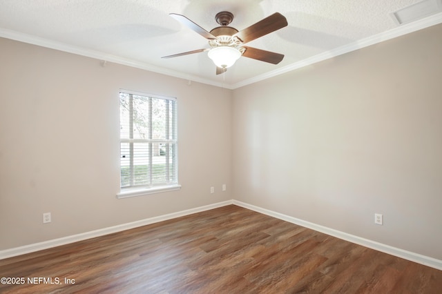 unfurnished room with visible vents, ceiling fan, baseboards, ornamental molding, and wood finished floors