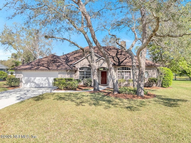 ranch-style home with concrete driveway, an attached garage, brick siding, and a front yard