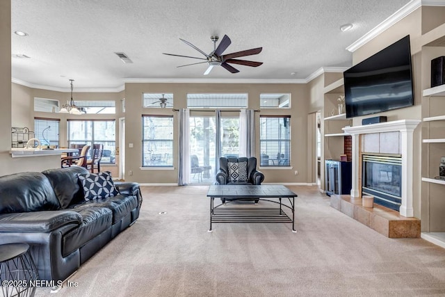 living room featuring crown molding, visible vents, carpet floors, and ceiling fan