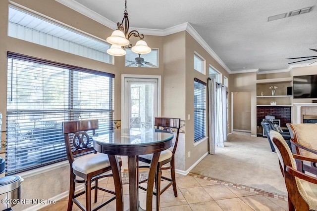 dining area featuring light tile patterned flooring, a ceiling fan, visible vents, and ornamental molding