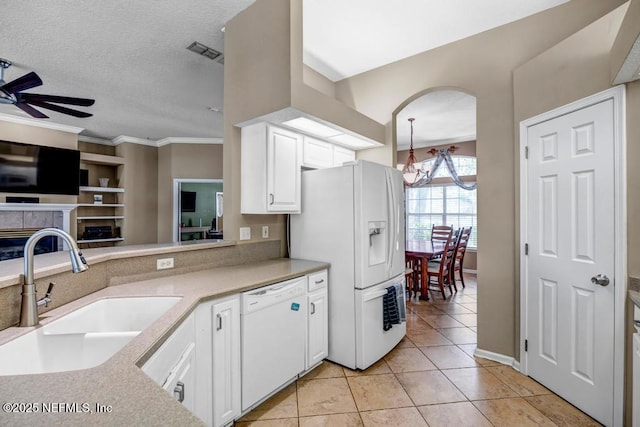 kitchen with visible vents, ceiling fan with notable chandelier, white appliances, white cabinetry, and a sink