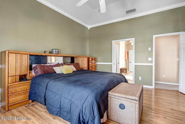 bedroom with baseboards, visible vents, light wood finished floors, ceiling fan, and ornamental molding