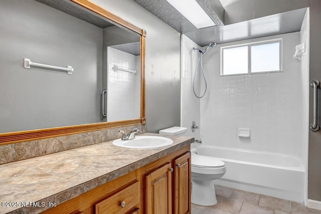 full bath featuring tub / shower combination, toilet, vanity, and tile patterned floors