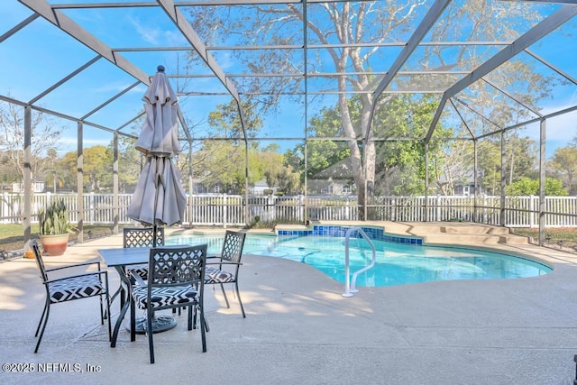 view of swimming pool with glass enclosure, a fenced in pool, a fenced backyard, and a patio area