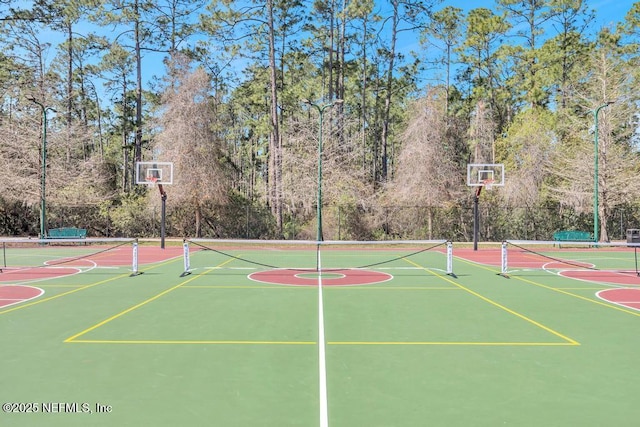 view of basketball court featuring community basketball court and fence