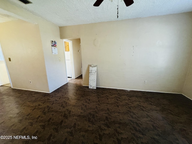 empty room with a textured ceiling and ceiling fan