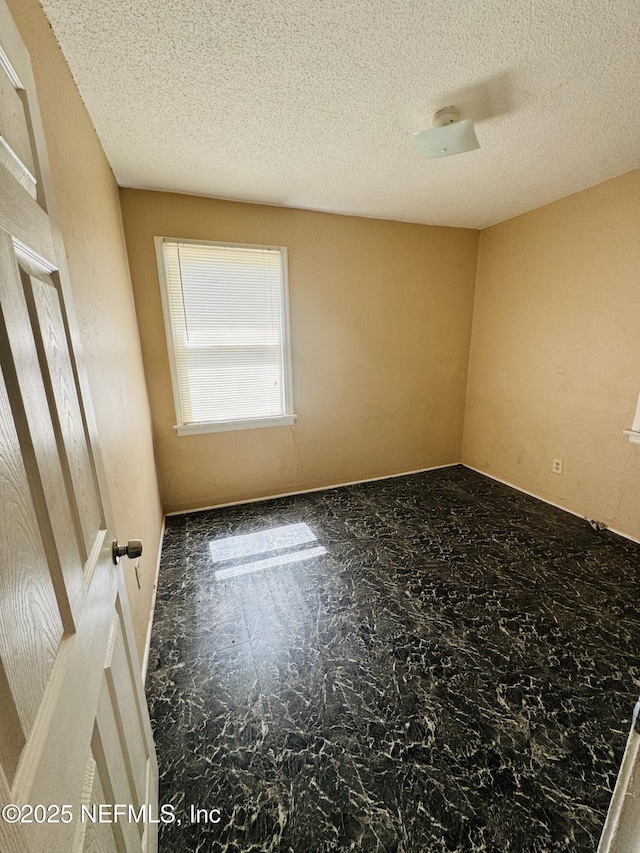 spare room featuring a textured ceiling