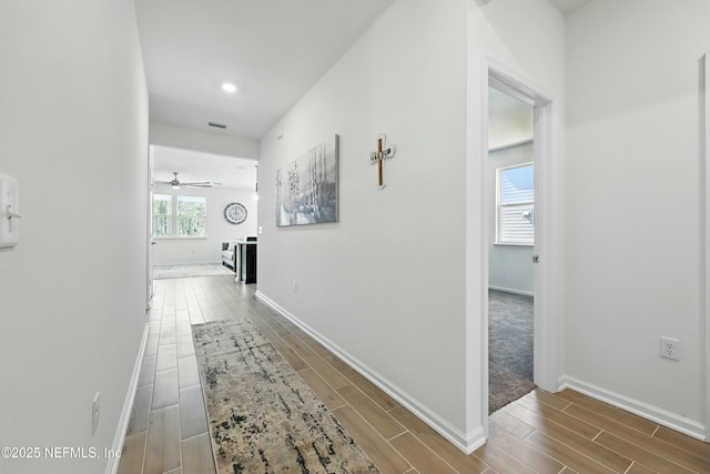 hall with recessed lighting, baseboards, and wood tiled floor