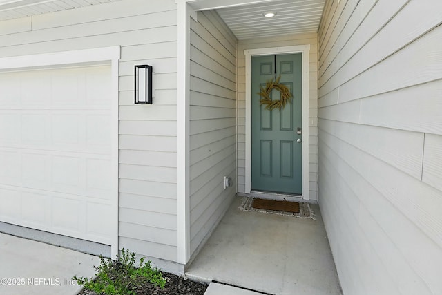 view of exterior entry with a garage