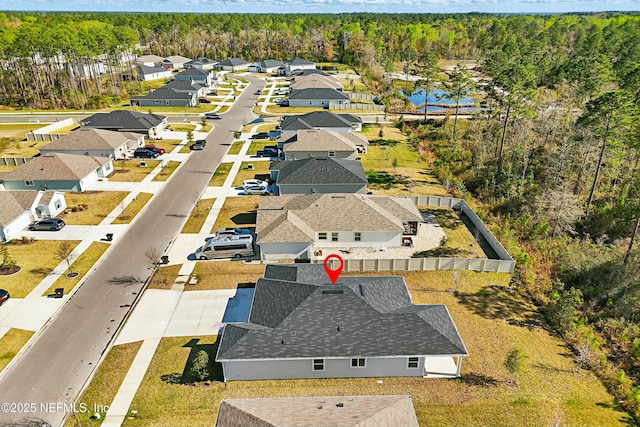 bird's eye view featuring a forest view and a residential view