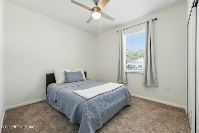 carpeted bedroom with a ceiling fan and baseboards