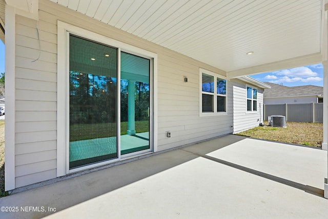 view of patio / terrace with central AC and fence