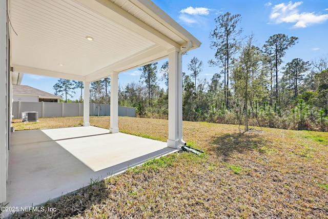 view of yard featuring cooling unit, a patio area, and fence