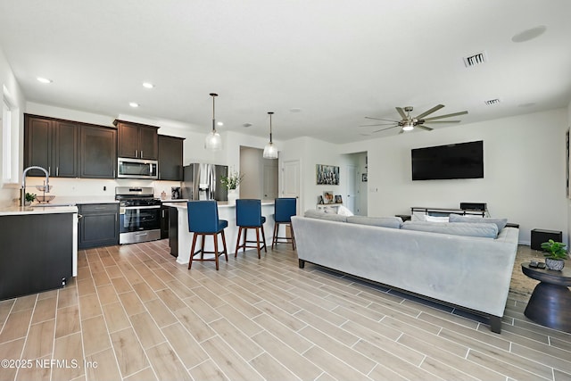 living room featuring visible vents, recessed lighting, light wood-style floors, and a ceiling fan