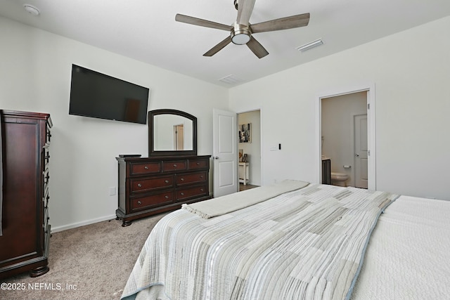 bedroom with baseboards, visible vents, ceiling fan, ensuite bathroom, and light carpet