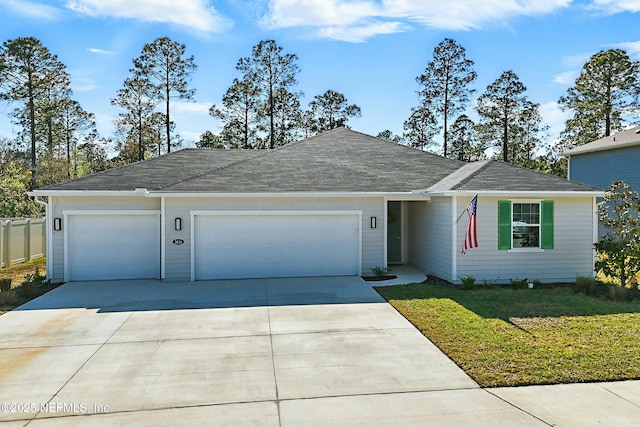 single story home with a garage, a front yard, and driveway